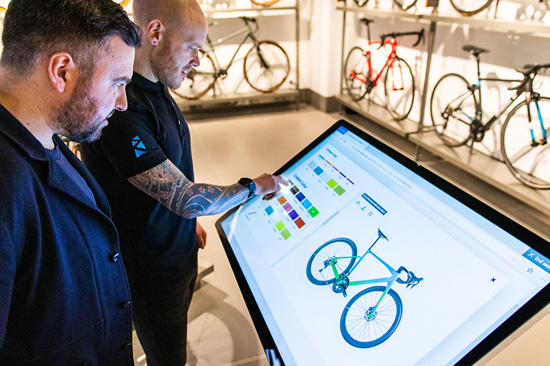 Two people using a Digi Sign commercial interactive touchscreen kiosk