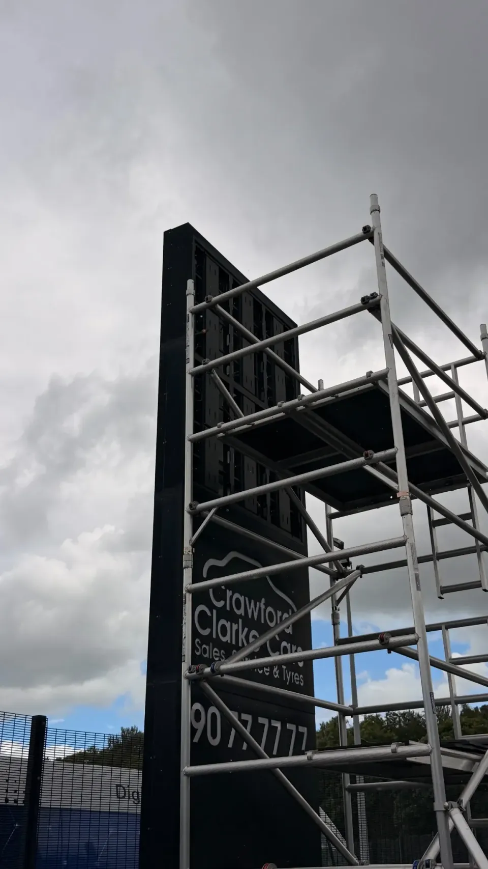 Side view of scaffolding and the dark upper display on the Crawford Clarke totem
