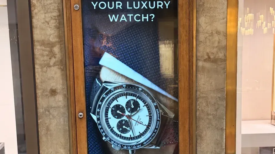Portrait watch advertisement on a digital window display at Lunn's Jewellers